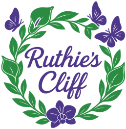 Ruthie's Cliff logo consisting of a stylized green floral wreath surrounded by three purple butterlies. Inside the wreath it reads in purple letters Ruthie's Cliff