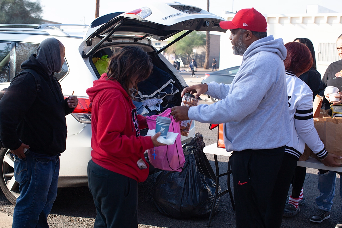 Volunteers preparing giveaway bags at Christmas charity event in the streets of Phoenix, AZ